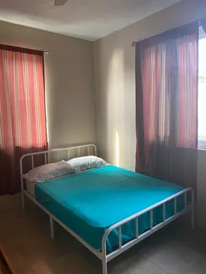 a bedroom with a bed with a blue mattress at Top of the Hill Blue Sunshine in Long Swamp