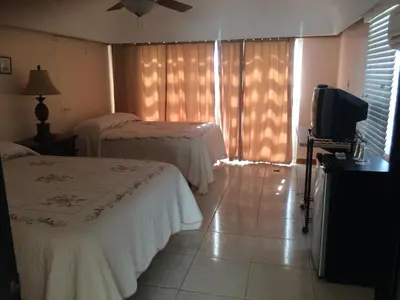 a hotel room with two beds and a television at Fort Burt Hotel in Road Town