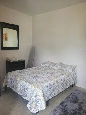 a bedroom with a bed and a mirror on the wall at Sage Mountain Skyway, Comfortable One Bedroom in Sage Mountain, Tortola in Great Carrot Bay