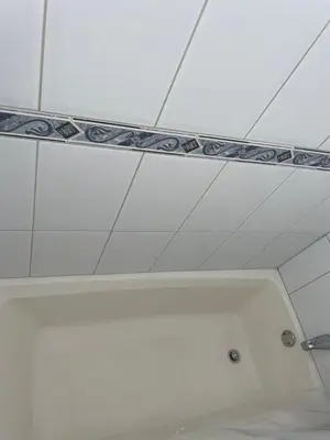 a white ceiling with a mirror in a bathroom at Ocean Breeze Comfort in East End