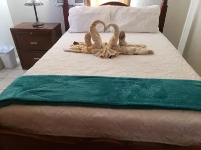 two swans made out of towels on a bed at Sailor's Gem in Tortola Island