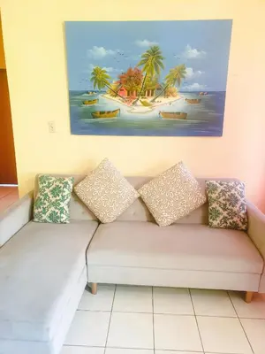 a couch in a room with a painting on the wall at Sailor's Gem in Tortola Island