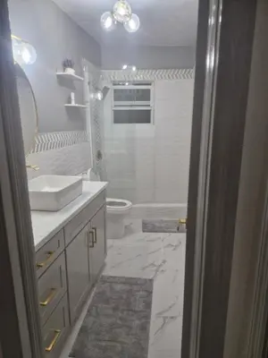 a white bathroom with a sink and a toilet at Cane Garden Bay 2 bed Apt in Leonards
