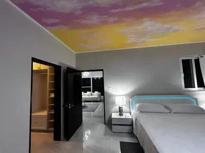 a bedroom with a bed and a painting on the ceiling at Zafira Luxe in Road Town