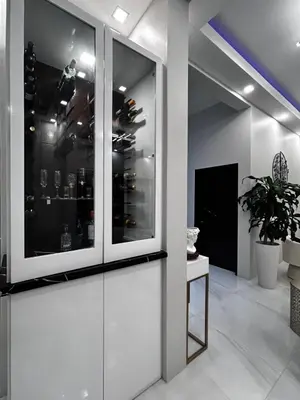 a glass door in a room with wine bottles at Zafira Luxe in Leonards