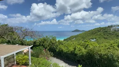 a view of the ocean from a house at BluEdge Villa VIP Resort Access in Tortola Island