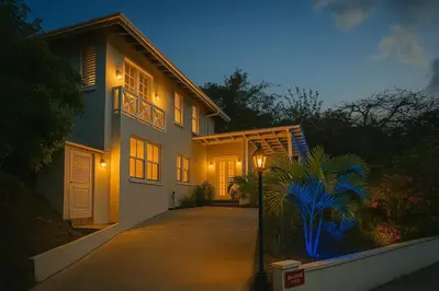 a house with a pathway leading to it at night at BluEdge Villa VIP Resort Access in Tortola Island