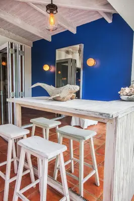 a counter with stools in a room with a shark skull on it at Endless Summer Villa in Tortola Island