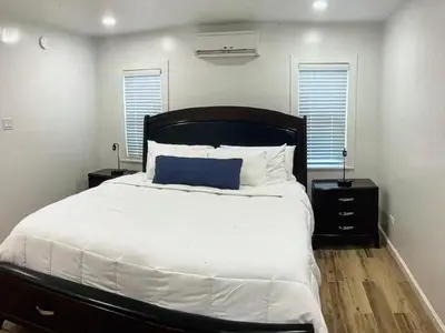 a bedroom with a large bed and two night stands at Amazing place on BVI in Road Town
