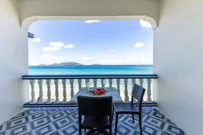 a table and chairs on a balcony with the ocean at Sebastian's on the beach hotel in Road Town