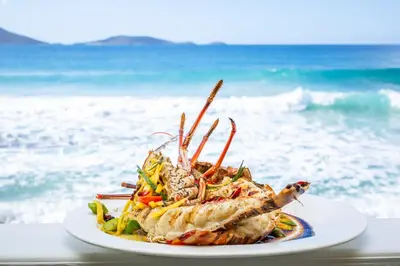 a plate of food on a table at the beach at Sebastian's on the beach hotel in Road Town