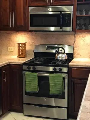 a kitchen with a stove with a tea kettle on it at Ocean View Villas in Jost Van Dyke