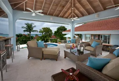 an outdoor patio with couches and chairs and a pool at BLUE LAGOON in Virgin Gorda
