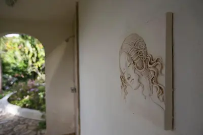 a picture on a wall with a carving on it at BELLAMARE in Virgin Gorda