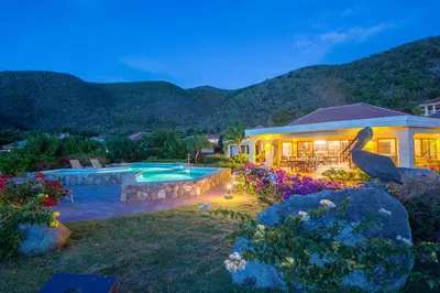 a house with a swimming pool in a yard at SANDCASTLE in Virgin Gorda