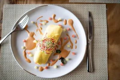 a white plate with a piece of food on it at Long Bay Beach Resort in Tortola Island
