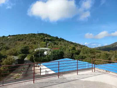 a view of a mountain from a balcony at More Than Beauty Properties in Tortola Island