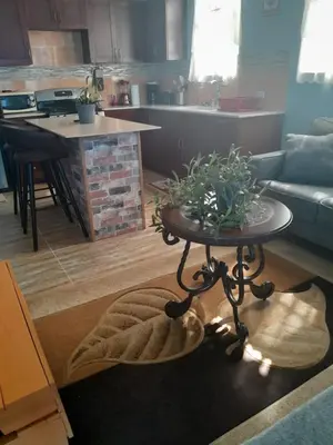 a living room with a table and a kitchen at Abigail's Spectacular 2 bedrooms-Entire Apartment in Tortola Island