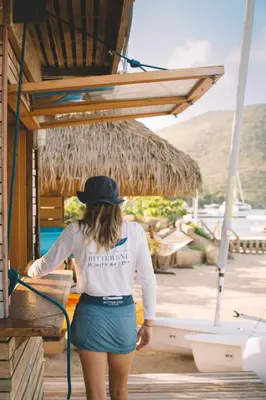 a woman is washing a boat with a hose at Bitter End Yacht Club in Virgin Gorda