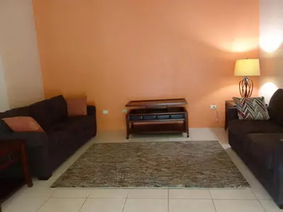a living room with a couch and a table at Abigail's Sunflower Entire 2 Bedroom Apt in Tortola Island